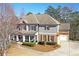 Well-maintained two-story home with a manicured lawn and mature trees at 114 Rock Creek Ln, Canton, GA 30114