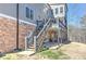 Stairway from deck to the yard showing stone foundation, covered patio, and backyard at 114 Rock Creek Ln, Canton, GA 30114