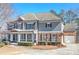 Charming two-story home featuring a inviting front porch and attached two car garage at 114 Rock Creek Ln, Canton, GA 30114