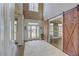 Welcoming foyer with hardwood floors, high ceilings, and stylish sliding barn doors at 114 Rock Creek Ln, Canton, GA 30114