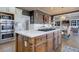 A large kitchen island has a gas cooktop and room for food prep and entertaining at 114 Rock Creek Ln, Canton, GA 30114
