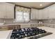 Well-equipped kitchen with stainless steel appliances, a farmhouse sink, and a stylish backsplash at 114 Rock Creek Ln, Canton, GA 30114