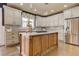 Well-lit kitchen has modern appliances, white countertops, kitchen island, and updated cabinets at 114 Rock Creek Ln, Canton, GA 30114
