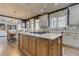 Spacious kitchen featuring an island cooktop, stainless appliances, and an open view to the dining area at 114 Rock Creek Ln, Canton, GA 30114