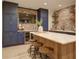 Finished basement kitchenette with blue cabinets, brick backsplash, island, and stainless steel appliances at 114 Rock Creek Ln, Canton, GA 30114