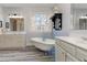 The main bathroom features a free standing tub, wood-look tile, and large window at 114 Rock Creek Ln, Canton, GA 30114