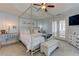 The main bedroom featuring a four-poster bed, sitting area, decorative lamps and French doors at 114 Rock Creek Ln, Canton, GA 30114