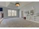 Serene primary bedroom with tray ceilings, natural light and sitting area at 114 Rock Creek Ln, Canton, GA 30114