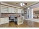 Spacious office featuring built-in shelving, a brick accent wall, and hardwood flooring at 114 Rock Creek Ln, Canton, GA 30114