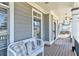 Cozy covered porch with comfortable seating and classic architectural details at 114 Rock Creek Ln, Canton, GA 30114