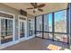 Spacious screened porch with ceiling fan and exterior views at 114 Rock Creek Ln, Canton, GA 30114