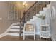 Charming staircase with decorative iron railings and hardwood floors, complemented by stylish accents at 114 Rock Creek Ln, Canton, GA 30114