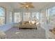 The sun room features walls of windows and a palm leaf ceiling fan at 114 Rock Creek Ln, Canton, GA 30114