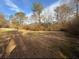 Large, level backyard with mature trees creating a peaceful setting at 214 S Lake Dr, Hiram, GA 30141