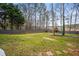 Large backyard with mature trees, shed, and play structure at 2164 Caneridge Sw Dr, Marietta, GA 30064