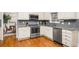 Well-lit kitchen featuring stainless steel appliances, granite countertops, and hardwood flooring at 2164 Caneridge Sw Dr, Marietta, GA 30064