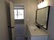 Bathroom with a modern vanity and mirror, offering a glimpse into an adjacent bedroom at 2401 Northlake Ct, Atlanta, GA 30345