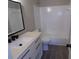 Modern bathroom showcasing sleek vanity, a matching mirror and a shower-tub combination at 2401 Northlake Ct, Atlanta, GA 30345