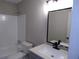 Bathroom featuring modern vanity and fixtures adjacent to tiled bath and shower at 2401 Northlake Ct, Atlanta, GA 30345