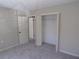 Neutral bedroom with neutral carpet and an open closet with a shelf at 2401 Northlake Ct, Atlanta, GA 30345