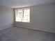 Bright bedroom featuring neutral walls, soft carpeting, and a large window for natural light at 2401 Northlake Ct, Atlanta, GA 30345