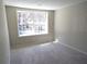 Bright bedroom featuring a large window and neutral carpet for a comfortable space at 2401 Northlake Ct, Atlanta, GA 30345