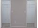 Bedroom featuring open closets with ample storage space and neutral carpeting at 2401 Northlake Ct, Atlanta, GA 30345
