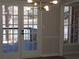 Dining area with French doors, water view, and modern light fixture at 2401 Northlake Ct, Atlanta, GA 30345