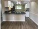 Open kitchen with granite counters, stainless steel appliances, and wood-look floors at 2401 Northlake Ct, Atlanta, GA 30345