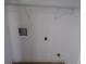 Laundry hookups in a white walled room with white shelves at 2401 Northlake Ct, Atlanta, GA 30345