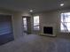 Spacious living room featuring a white fireplace, neutral carpeting, and bright sunny windows at 2401 Northlake Ct, Atlanta, GA 30345