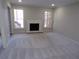 Cozy living room featuring a classic fireplace and abundant natural light from large windows at 2401 Northlake Ct, Atlanta, GA 30345