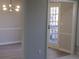 Open-concept living area featuring a modern light fixture and wood flooring at 2401 Northlake Ct, Atlanta, GA 30345