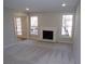 Spacious living room featuring a white fireplace, neutral carpeting, and bright sunny windows at 2401 Northlake Ct, Atlanta, GA 30345