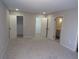 A main bedroom with neutral walls, plush carpet, recessed lighting, and access to closets and bathroom at 2401 Northlake Ct, Atlanta, GA 30345