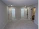 A main bedroom with neutral walls, plush carpet, recessed lighting, and access to closets and bathroom at 2401 Northlake Ct, Atlanta, GA 30345
