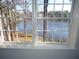 Window showcasing a tranquil view of a serene lake surrounded by lush trees and greenery at 2401 Northlake Ct, Atlanta, GA 30345