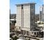Modern high-rise building with multi-story windows and cylindrical elements at 2881 Peachtree Ne Rd # 702, Atlanta, GA 30305