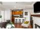 Open-concept living area with kitchen view, hardwood floors, and a cozy fireplace at 2881 Peachtree Ne Rd # 702, Atlanta, GA 30305