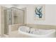 Close up of the spa like main bathroom featuring a garden soaking tub and walk in shower at 2881 Peachtree Ne Rd # 702, Atlanta, GA 30305