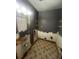 Bathroom features wall damage, a mirror, and a toilet at 405 Fairburn Sw Rd, Atlanta, GA 30331