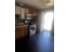 Kitchen area with wood cabinets, an oven and stove, and wood floors at 405 Fairburn Sw Rd, Atlanta, GA 30331