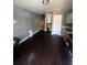 Inviting living room featuring hardwood floors, stairs, and a small kitchenette area at 405 Fairburn Sw Rd, Atlanta, GA 30331