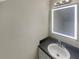 Cozy half bathroom with a large, lighted mirror and under-mount sink at 5676 Kingsport Dr # 4, Atlanta, GA 30342