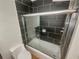 Bathroom with black tiled shower and glass shower door at 5676 Kingsport Dr # 4, Atlanta, GA 30342
