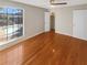 Bright bedroom with a ceiling fan, hardwood floors, and a view of the backyard pool at 5676 Kingsport Dr # 4, Atlanta, GA 30342
