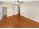 Large bedroom with hardwood floors, a ceiling fan, and direct access to a walk-in closet at 5676 Kingsport Dr # 4, Atlanta, GA 30342