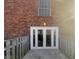 A building entrance featuring glass doors, a window above and brick walls at 5676 Kingsport Dr # 4, Atlanta, GA 30342