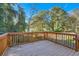 Large back deck with wooden planks and railing, overlooking a lush backyard at 1532 Pineview Sw Ter, Atlanta, GA 30311