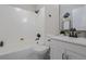 Modern bathroom with a sleek design, white tile, and black fixtures at 1532 Pineview Sw Ter, Atlanta, GA 30311